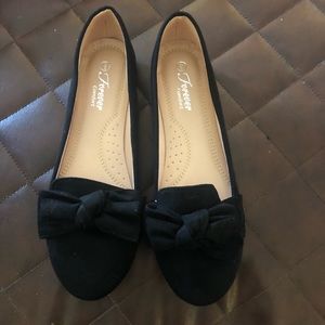 Black faux suede flats with bow